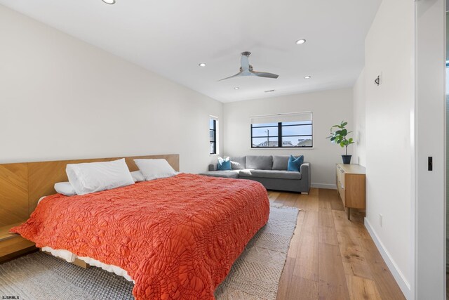 bedroom with light hardwood / wood-style floors and ceiling fan