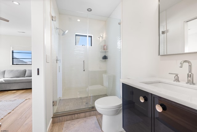 bathroom with walk in shower, vanity, toilet, and hardwood / wood-style flooring