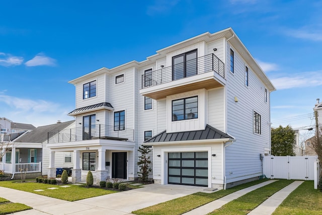 view of front of house with a garage, a balcony, and a front lawn