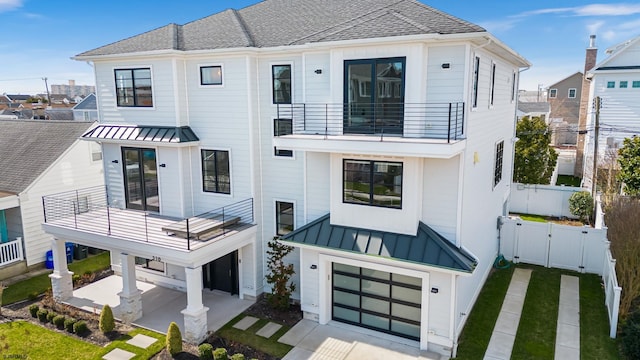 view of front of house with a garage and a balcony