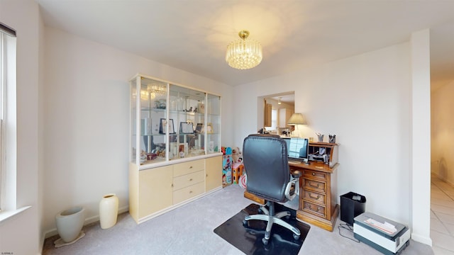 carpeted office space featuring a notable chandelier