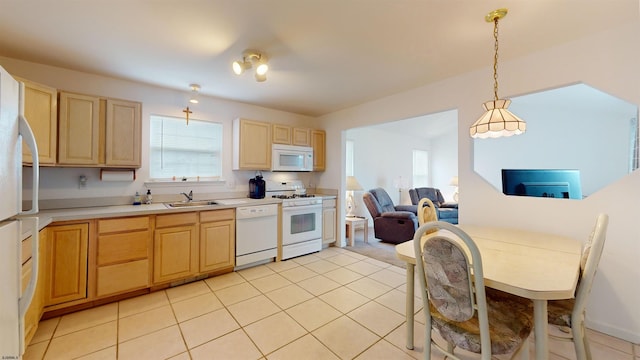 kitchen featuring white appliances, pendant lighting, light tile floors, and sink