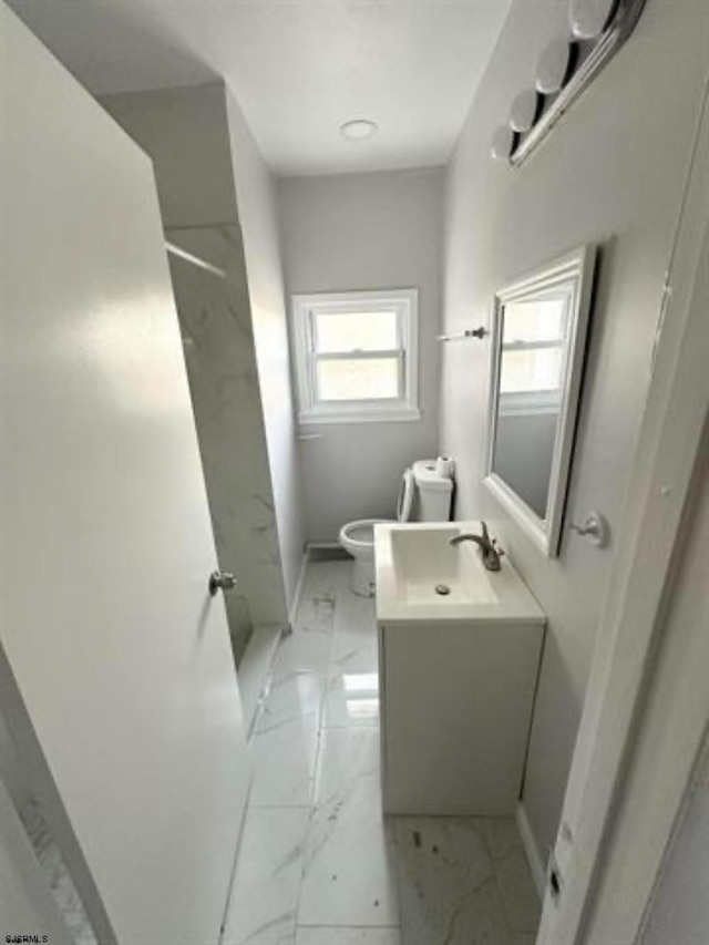 bathroom featuring toilet, vanity, and tile flooring