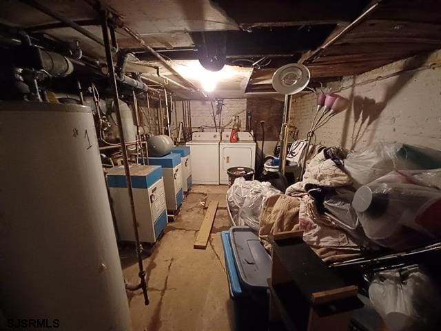 basement featuring washing machine and dryer and water heater