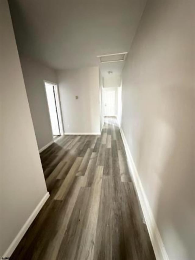 hallway with dark wood-type flooring