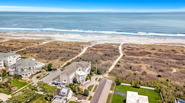 bird's eye view featuring a view of the beach and a water view