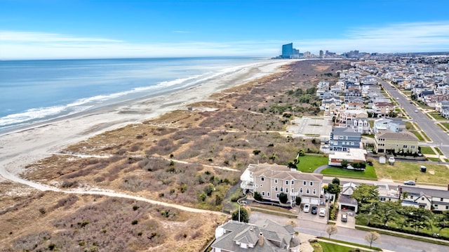 birds eye view of property featuring a view of the beach and a water view