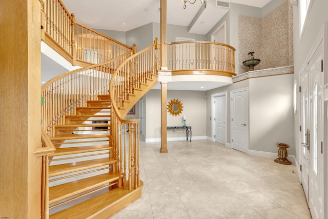 tiled entryway with a high ceiling