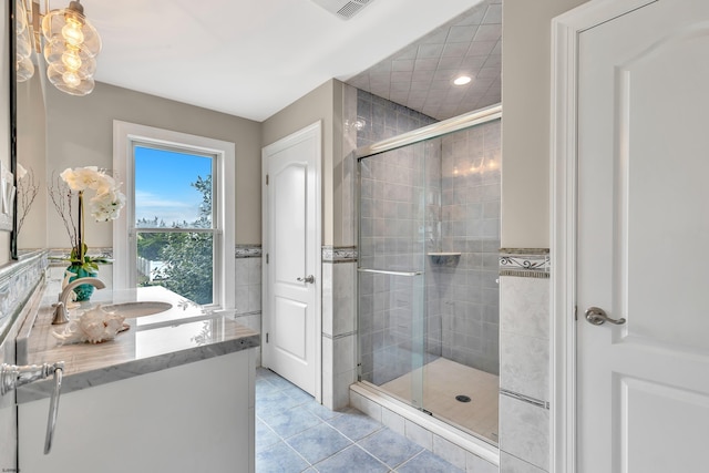 bathroom with an enclosed shower, tile floors, and vanity