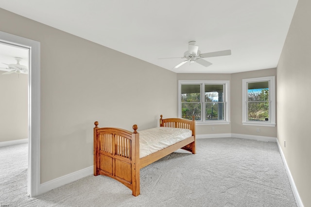 bedroom featuring ceiling fan and light carpet