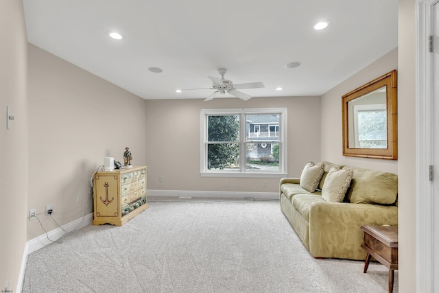 sitting room with light colored carpet and ceiling fan