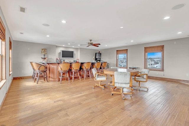 dining area featuring ceiling fan and light wood-type flooring