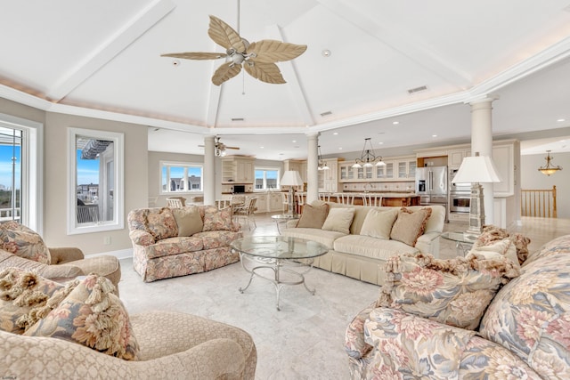 tiled living room featuring plenty of natural light, ornate columns, and ceiling fan