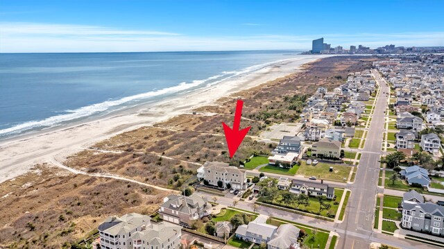 birds eye view of property featuring a view of the beach and a water view