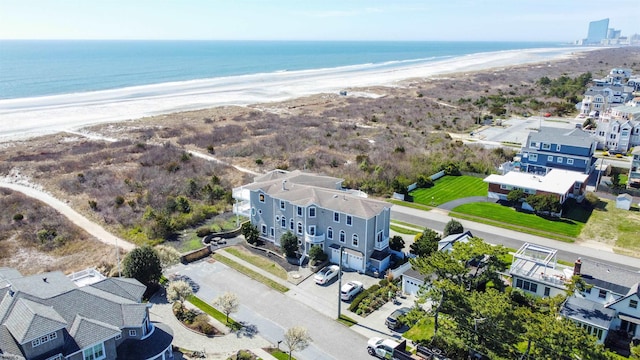 birds eye view of property featuring a beach view and a water view