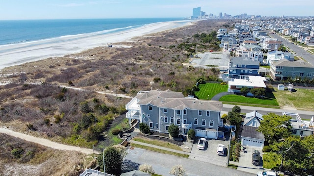 birds eye view of property featuring a beach view and a water view