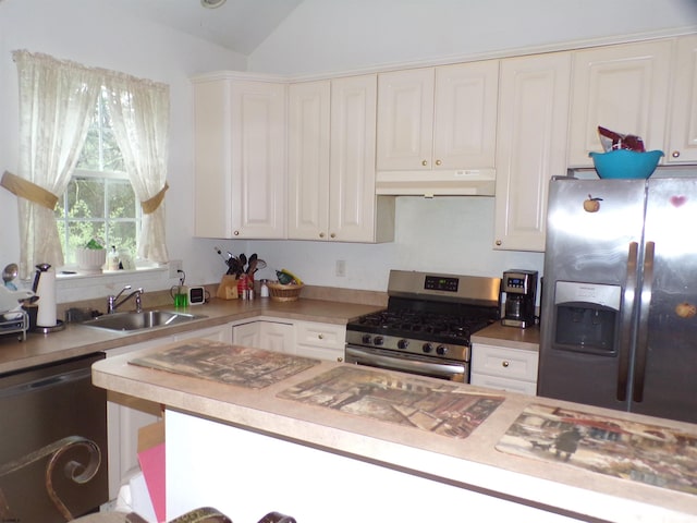 kitchen with white cabinets, sink, lofted ceiling, and stainless steel appliances