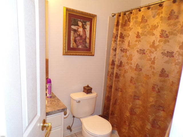 bathroom featuring toilet, tile floors, and vanity