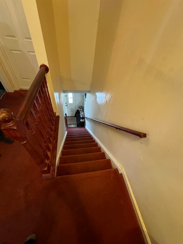 stairway with dark colored carpet