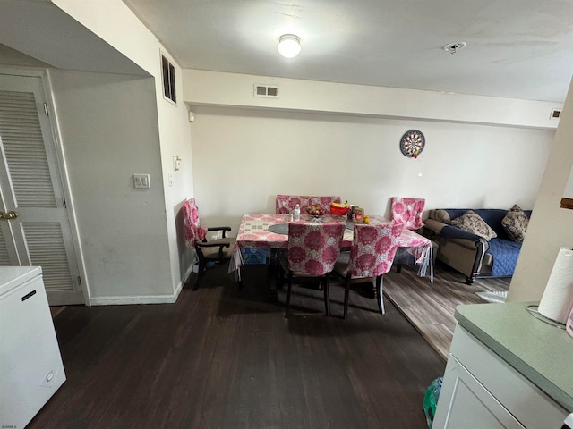 dining area featuring dark hardwood / wood-style flooring