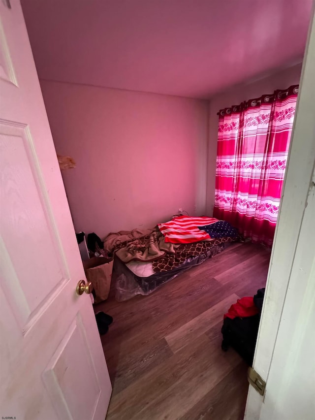 bedroom with dark hardwood / wood-style flooring