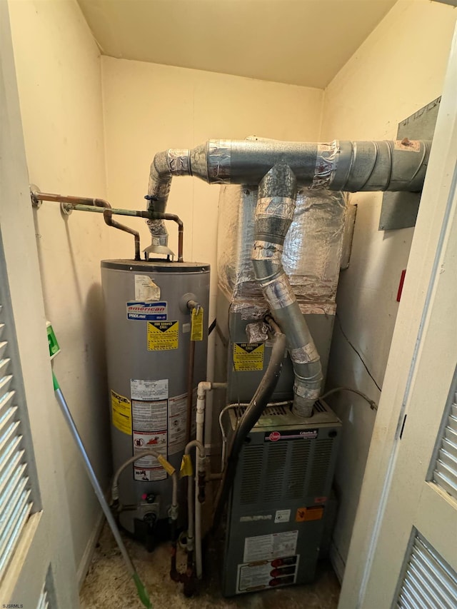 utility room featuring water heater