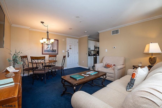 living room featuring ornamental molding, a chandelier, and carpet flooring