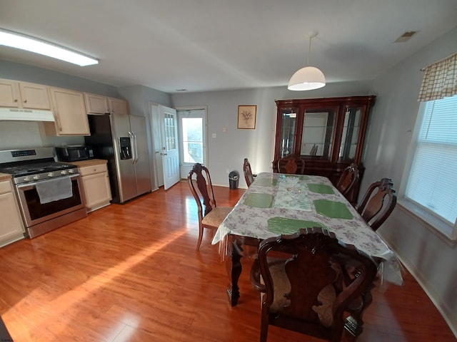 dining space featuring light wood-type flooring