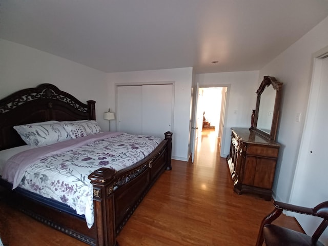 bedroom with a closet and dark hardwood / wood-style floors