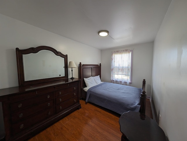 bedroom with dark hardwood / wood-style floors