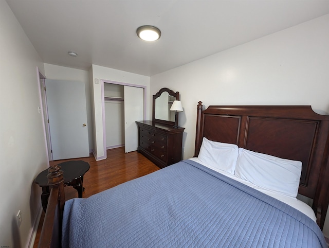 bedroom featuring a closet and dark hardwood / wood-style floors