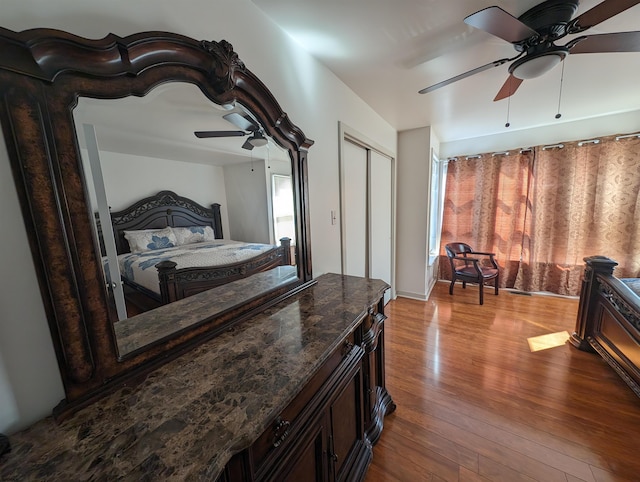 interior space featuring a closet, wood-type flooring, and ceiling fan