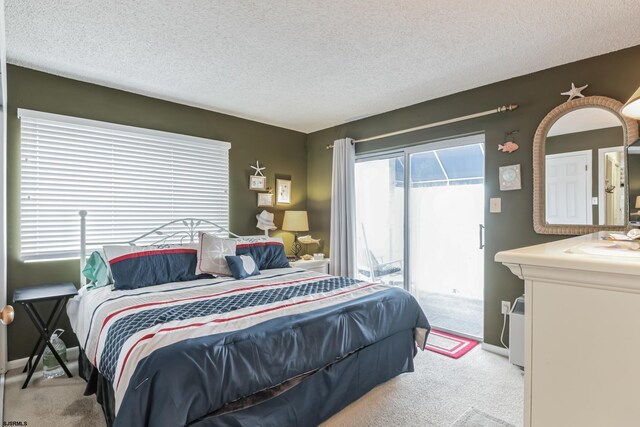 carpeted bedroom featuring sink and a textured ceiling