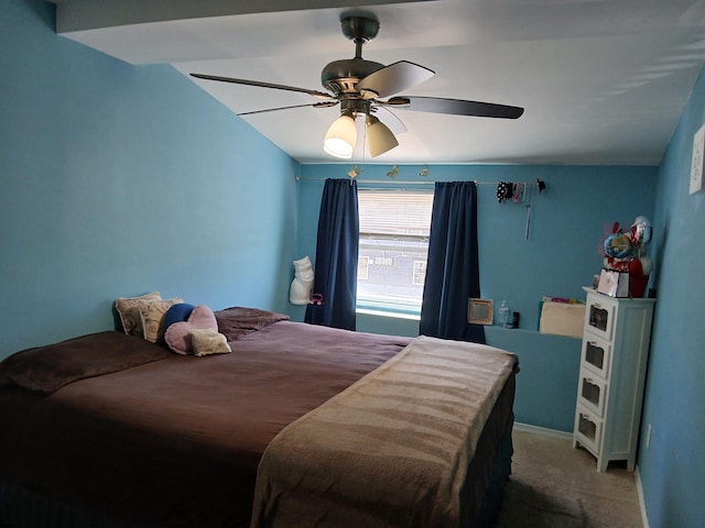 carpeted bedroom with vaulted ceiling and ceiling fan