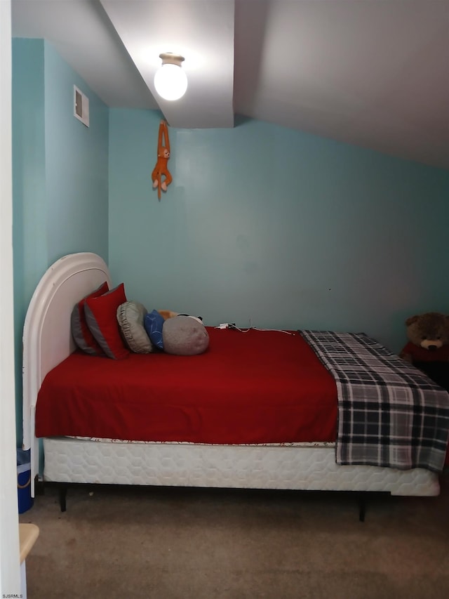 carpeted bedroom with lofted ceiling