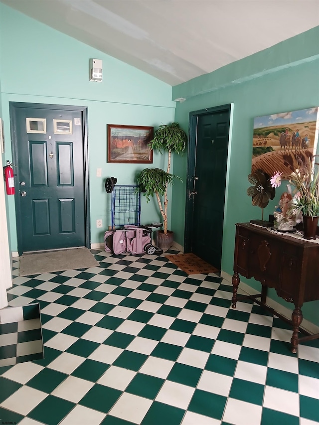 tiled foyer entrance with vaulted ceiling