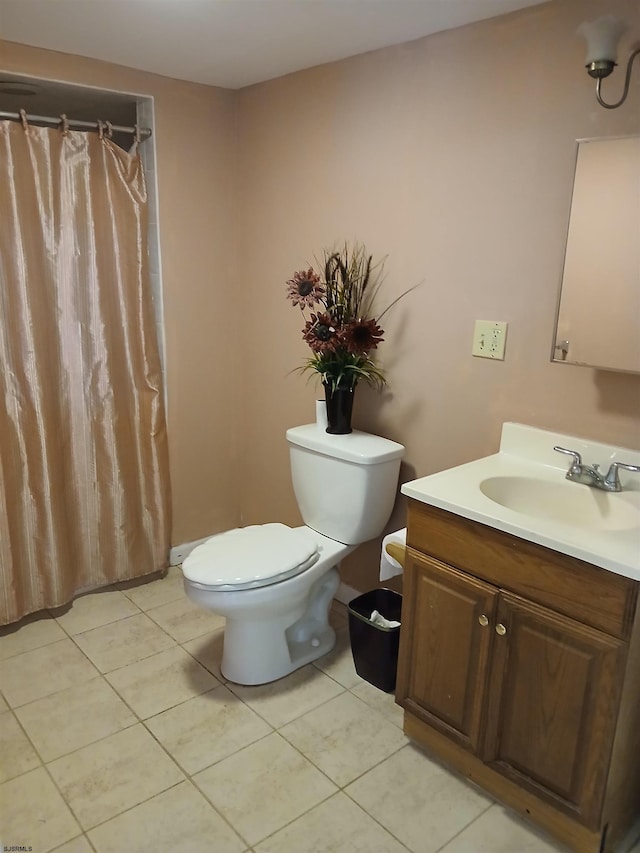 bathroom featuring vanity, toilet, and tile floors