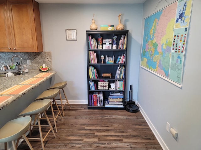 dining room with sink and dark hardwood / wood-style floors