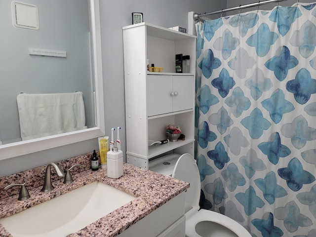 bathroom featuring vanity and toilet