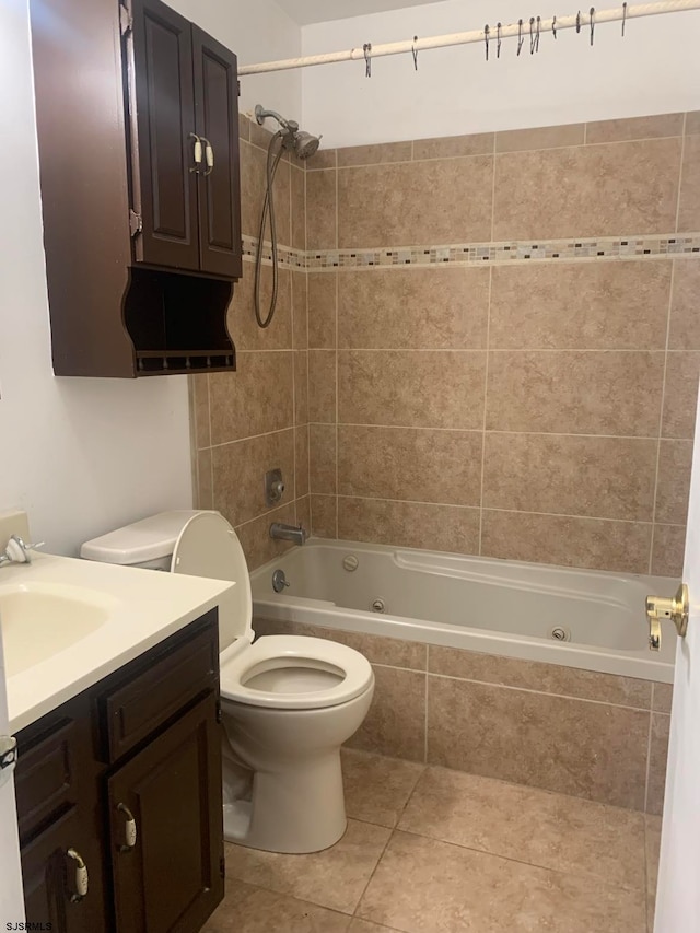 full bathroom with tiled shower / bath, vanity, toilet, and tile flooring