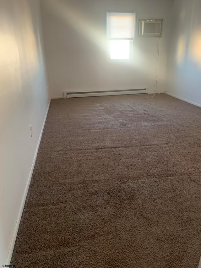 spare room with dark carpet, baseboard heating, and a wall mounted AC