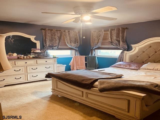 carpeted bedroom with ceiling fan