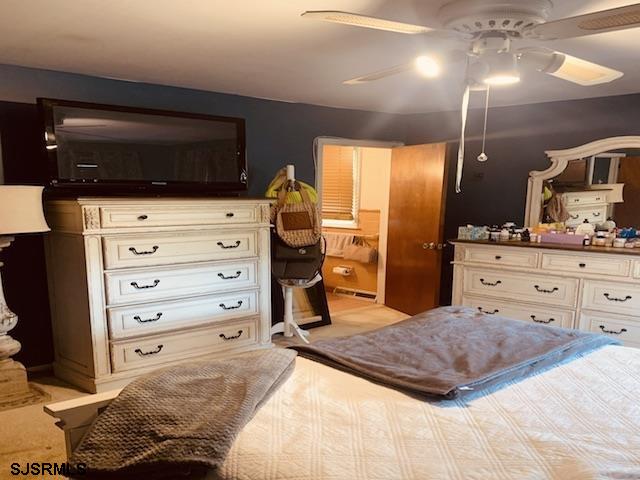 carpeted bedroom with ceiling fan