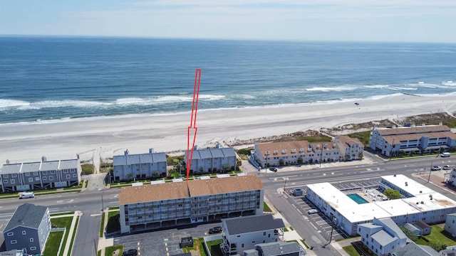 bird's eye view featuring a water view and a beach view