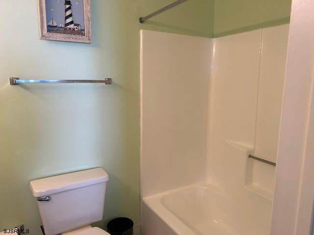 bathroom with shower / tub combination and toilet