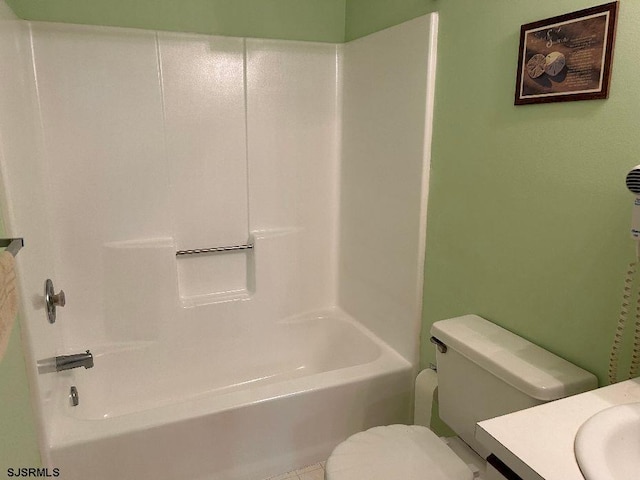 full bathroom featuring toilet, vanity, and tub / shower combination