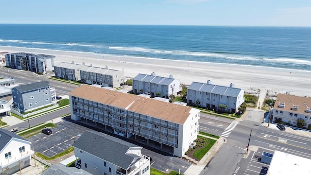 aerial view with a water view and a view of the beach