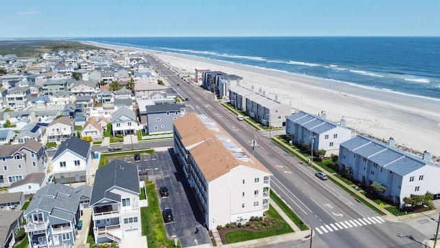 bird's eye view featuring a water view and a beach view