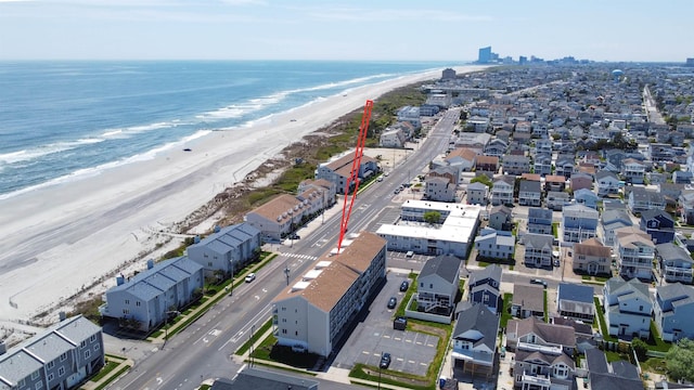 birds eye view of property with a view of the beach and a water view