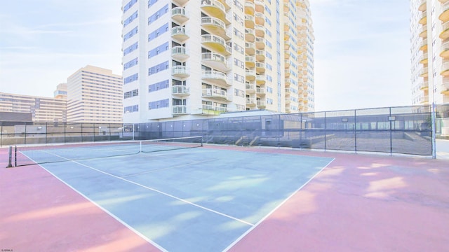 view of tennis court featuring fence